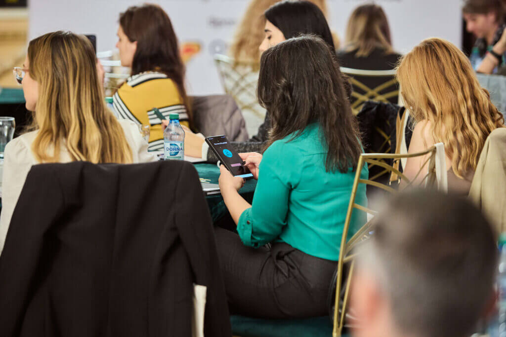people using Stickeroo app at an event